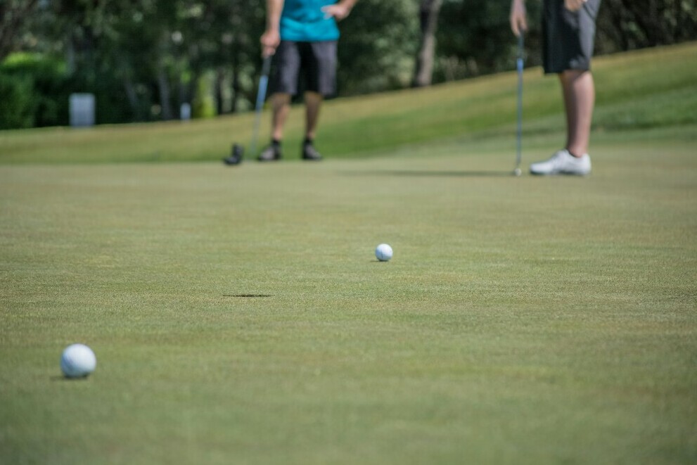 golfers on a green